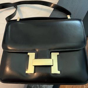 Small, black Hermes bag with gold